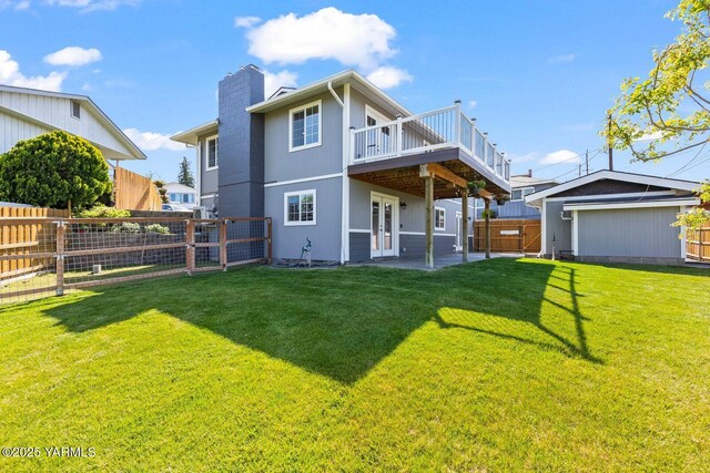 rear view of property with a deck, a chimney, a patio, and french doors