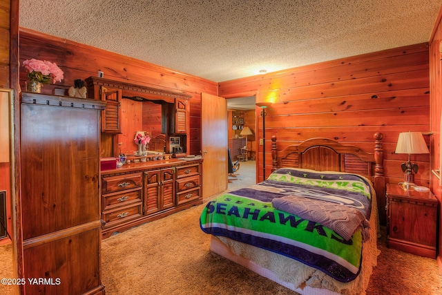 carpeted bedroom featuring a textured ceiling and wooden walls