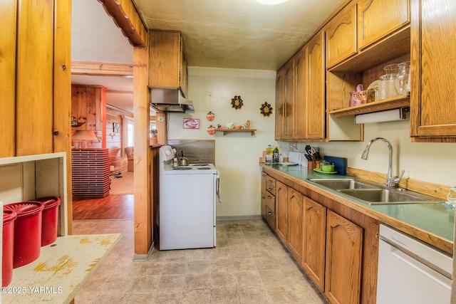 kitchen with white appliances, baseboards, brown cabinets, under cabinet range hood, and a sink