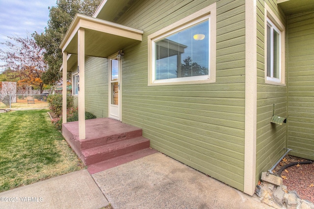 view of exterior entry with fence