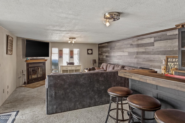 3603 Carol Ave, Yakima, WA 98902 - indoor dry bar featuring a glass covered fireplace, a textured ceiling, wooden walls, and carpet