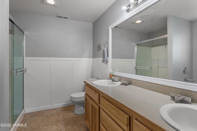 710 Columbus Ave, Moxee, WA 98936 - bathroom with a stall shower, double vanity, and wainscoting