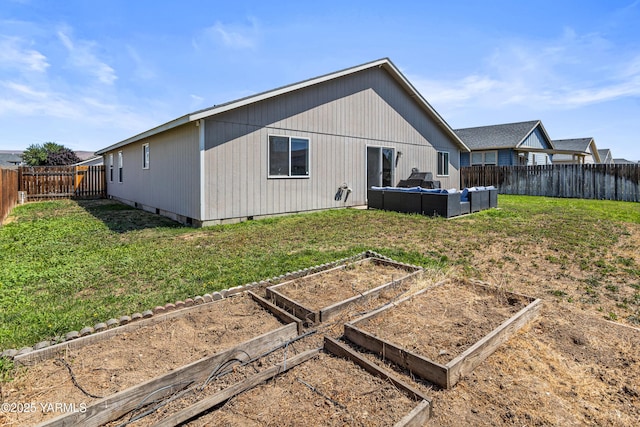 710 Columbus Ave, Moxee, WA 98936 - rear view of property featuring an outdoor hangout area, a garden, and a fenced backyard