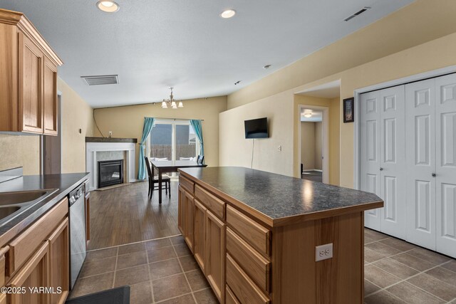 710 Columbus Ave, Moxee, WA 98936 - kitchen featuring dark countertops, stainless steel dishwasher, a center island, dark tile patterned floors, and recessed lighting