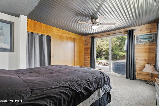 310 Sage Trail Rd, Yakima, WA 98901 - bedroom featuring access to exterior, light carpet, wooden walls, and a ceiling fan