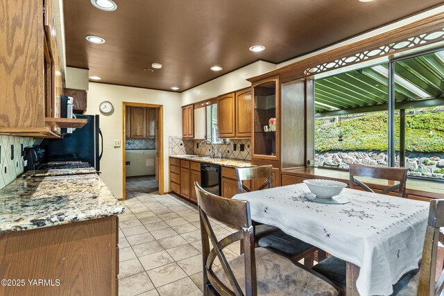 611 Ferncrest Rd, Yakima, WA 98901 - kitchen with backsplash, brown cabinetry, and baseboards