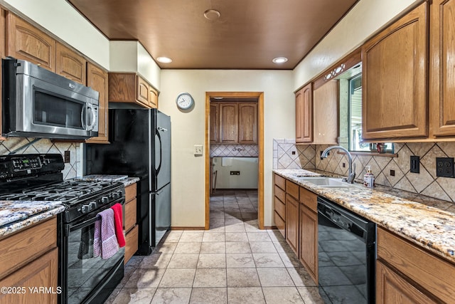 611 Ferncrest Rd, Yakima, WA 98901 - kitchen featuring a sink, decorative backsplash, light stone counters, brown cabinetry, and black appliances