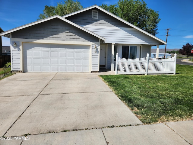 view of front of home with a garage, a front lawn, driveway, and a porch