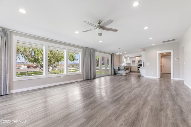 851 E Selah Rd, Yakima, WA 98901 - unfurnished living room featuring a ceiling fan, recessed lighting, baseboards, a chandelier, and light wood-type flooring