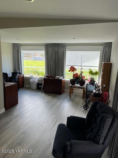 living area featuring wood finished floors and baseboards