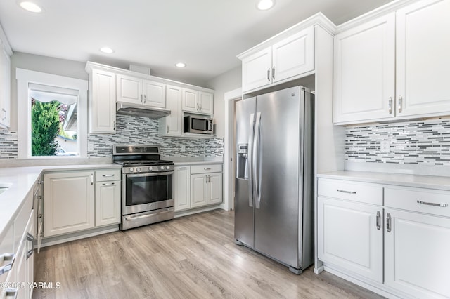 851 E Selah Rd, Yakima, WA 98901 - kitchen with appliances with stainless steel finishes, backsplash, white cabinetry, light countertops, and recessed lighting