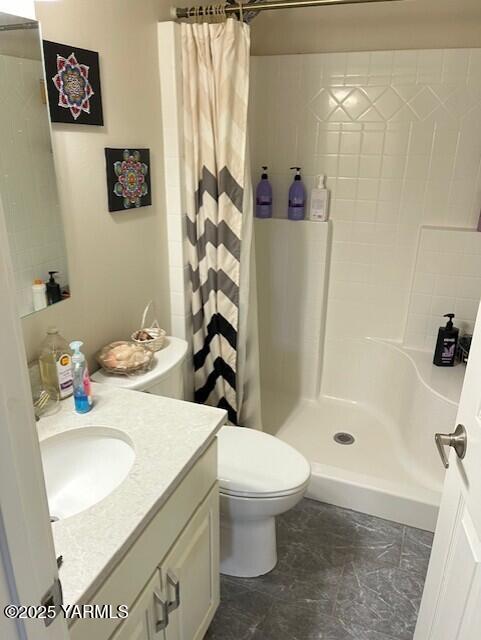 full bath with a shower stall, toilet, and vanity