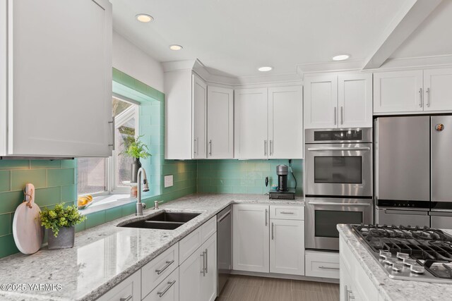 5 N 80th Ave, Yakima, WA 98908 - kitchen with stainless steel appliances, white cabinetry, a sink, and backsplash
