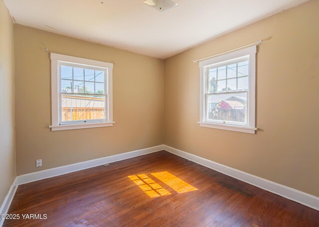 1309 W Spruce St, Yakima, WA 98902 - spare room with healthy amount of natural light, wood finished floors, and baseboards