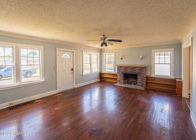 1309 W Spruce St, Yakima, WA 98902 - unfurnished living room with dark wood-type flooring, a textured ceiling, ceiling fan, healthy amount of natural light, and baseboards