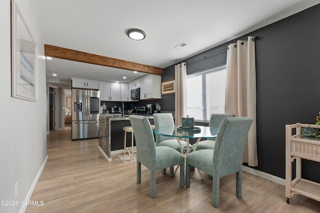 dining space with recessed lighting, visible vents, baseboards, light wood-type flooring, and beamed ceiling