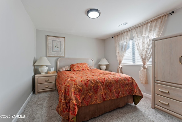 bedroom featuring carpet floors, visible vents, and baseboards