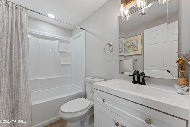 bathroom featuring toilet, shower / bath combo with shower curtain, and vanity