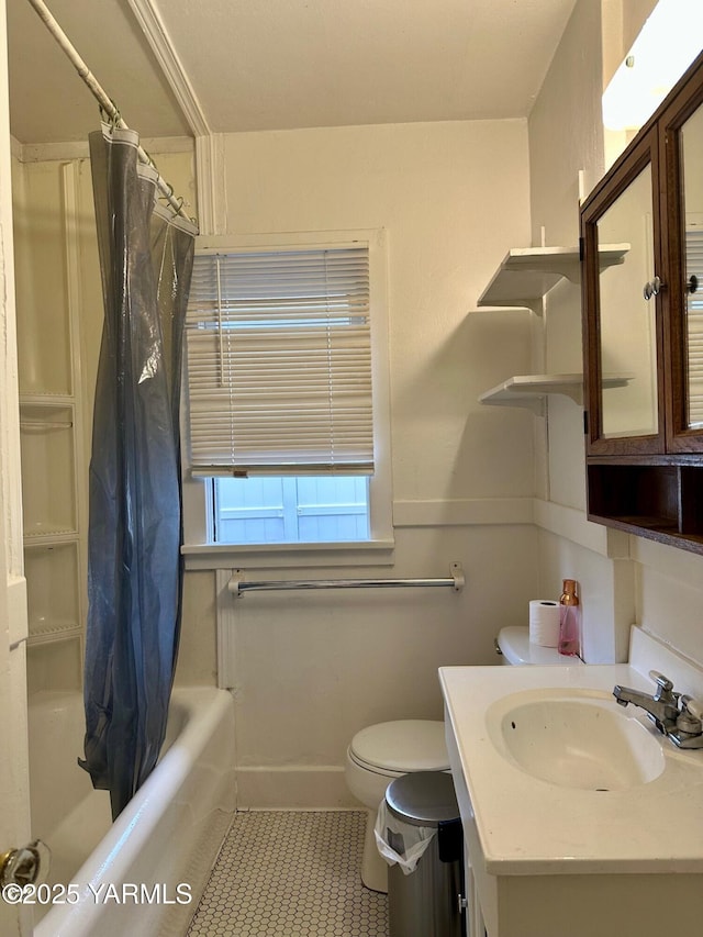 bathroom featuring baseboards, toilet, shower / tub combo with curtain, tile patterned flooring, and vanity