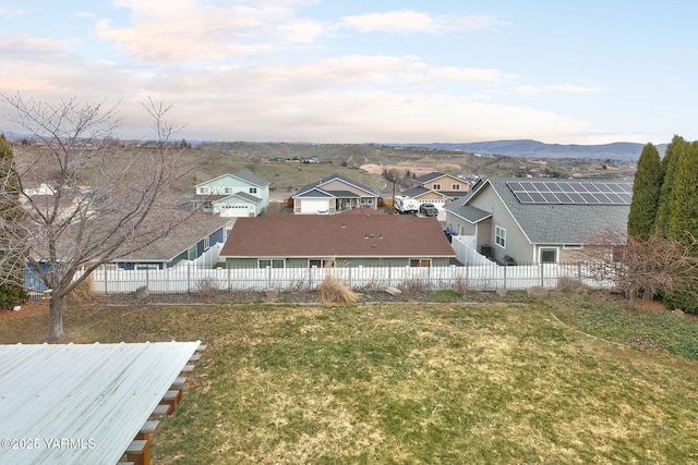 exterior space with a residential view, a mountain view, and fence