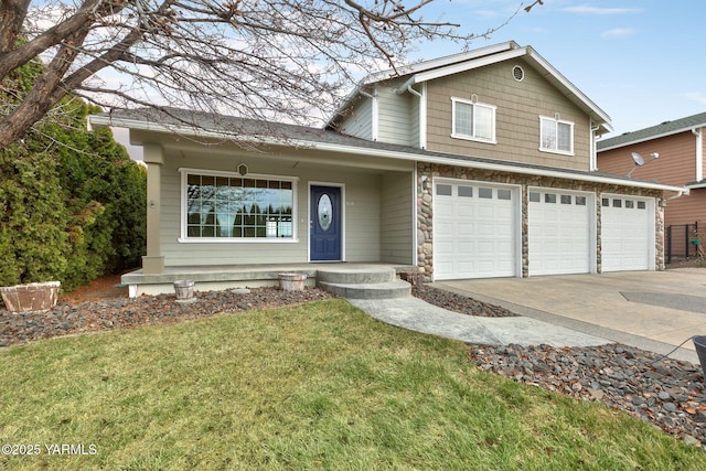 traditional-style house with stone siding, a front lawn, concrete driveway, and a garage