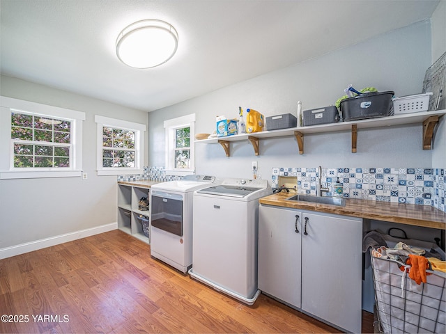 230 Krough Rd, Prosser, WA 99350 - laundry room with a sink, light wood-type flooring, cabinet space, and washing machine and clothes dryer