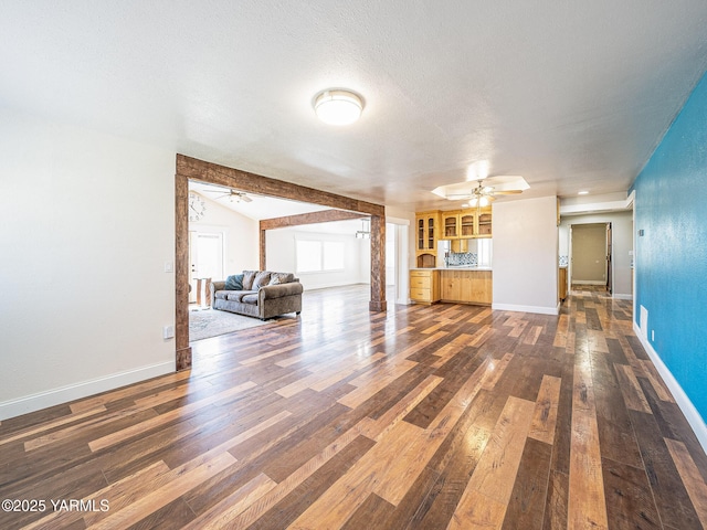230 Krough Rd, Prosser, WA 99350 - unfurnished living room with baseboards, ceiling fan, dark wood-style floors, and a textured ceiling