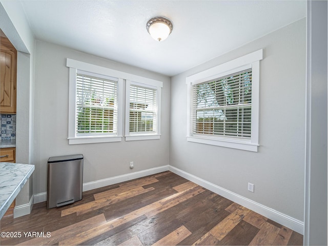 230 Krough Rd, Prosser, WA 99350 - unfurnished dining area with baseboards and dark wood-type flooring