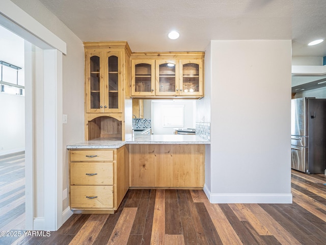 230 Krough Rd, Prosser, WA 99350 - kitchen with freestanding refrigerator, dark wood-style flooring, light brown cabinetry, glass insert cabinets, and light countertops