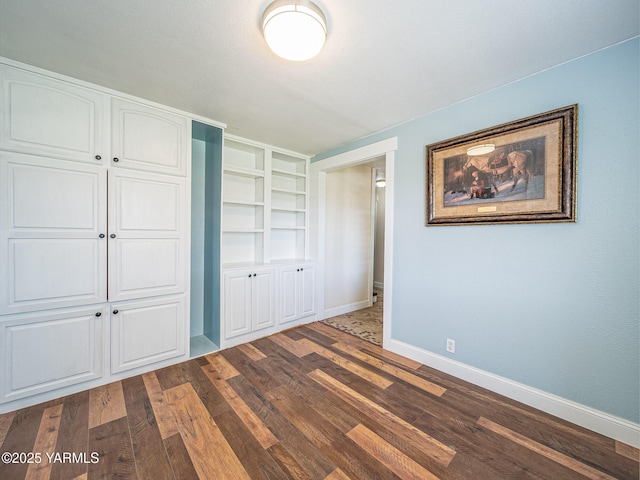 230 Krough Rd, Prosser, WA 99350 - unfurnished bedroom with baseboards, a closet, and dark wood finished floors
