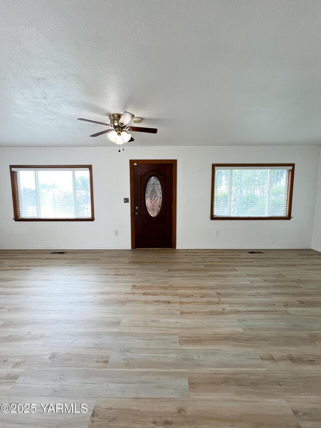 63 W Mead Ave, Yakima, WA 98902 - entryway with light wood-type flooring, ceiling fan, plenty of natural light, and a textured ceiling