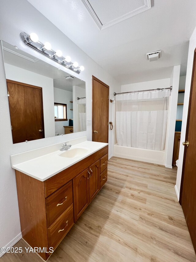 63 W Mead Ave, Yakima, WA 98902 - full bath with vanity, wood finished floors, shower / bath combo, and toilet