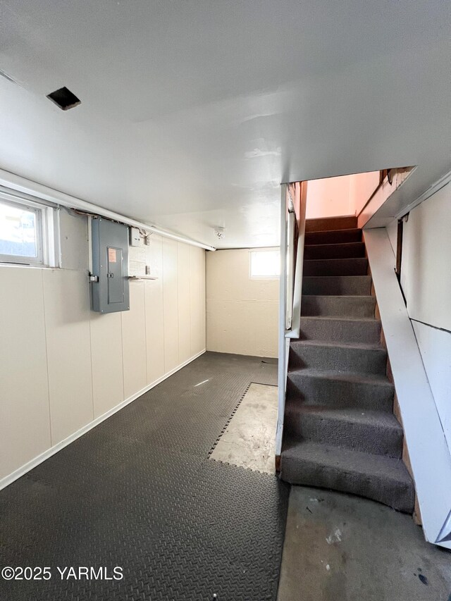 63 W Mead Ave, Yakima, WA 98902 - basement featuring electric panel, stairway, healthy amount of natural light, and carpet flooring