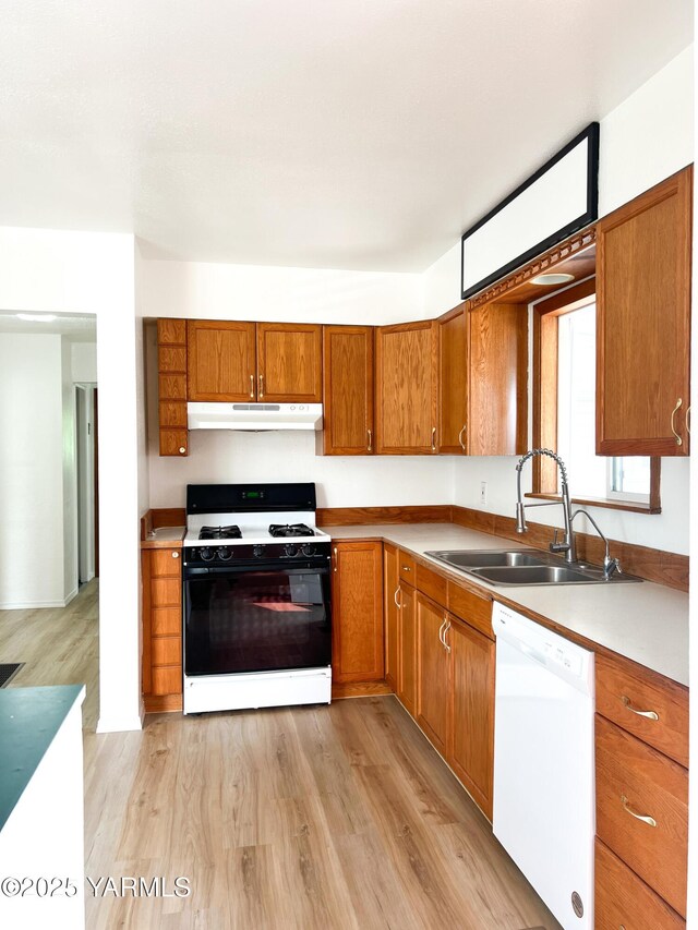 63 W Mead Ave, Yakima, WA 98902 - kitchen with dishwasher, range with gas cooktop, a sink, brown cabinets, and under cabinet range hood