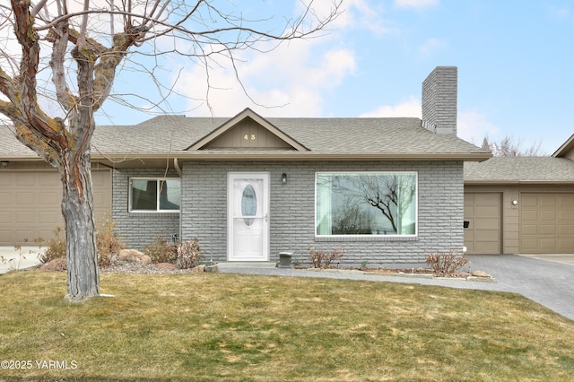 ranch-style house with driveway, a shingled roof, a chimney, a front lawn, and brick siding