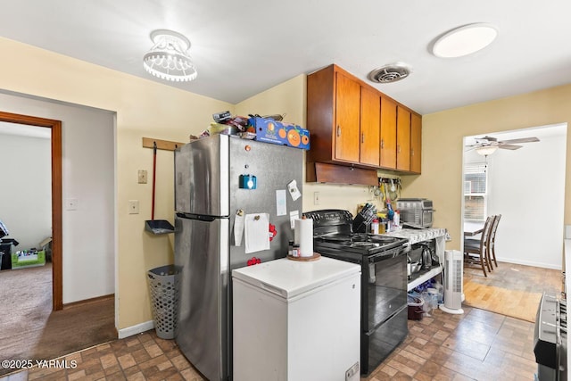 1306 S 6th Ave, Yakima, WA 98902 - kitchen featuring black / electric stove, freestanding refrigerator, light countertops, ceiling fan, and brown cabinetry