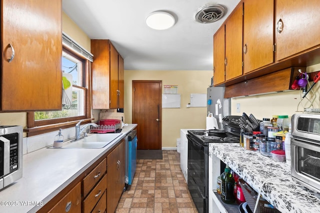 1306 S 6th Ave, Yakima, WA 98902 - kitchen with black / electric stove, stainless steel microwave, light countertops, brown cabinetry, and dishwasher