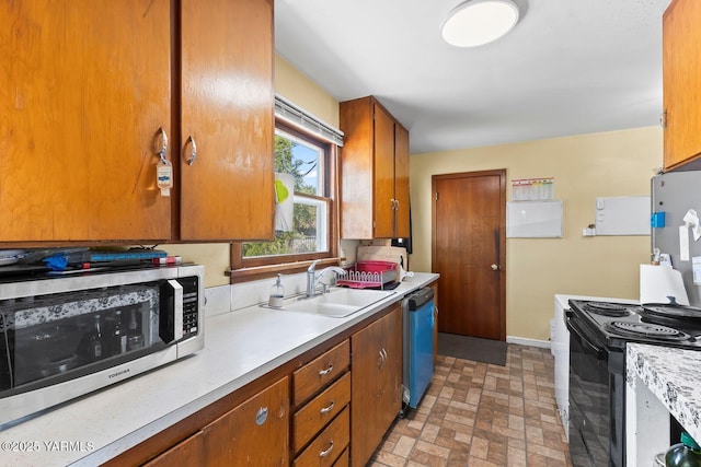 1306 S 6th Ave, Yakima, WA 98902 - kitchen with stainless steel microwave, dishwasher, light countertops, brick patterned flooring, and brown cabinetry