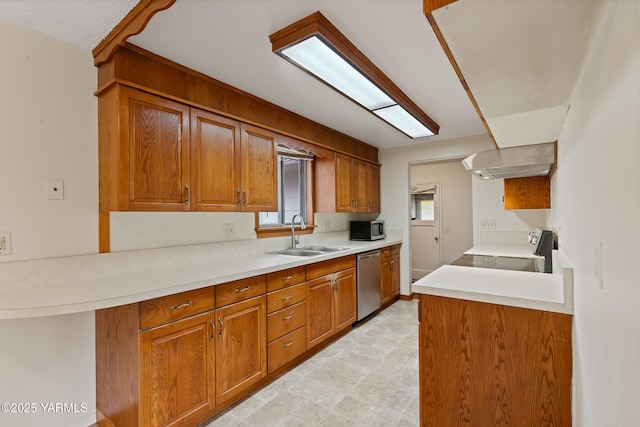 4905 Glenside Ct, Yakima, WA 98908 - kitchen featuring a sink, appliances with stainless steel finishes, brown cabinets, wall chimney range hood, and light countertops