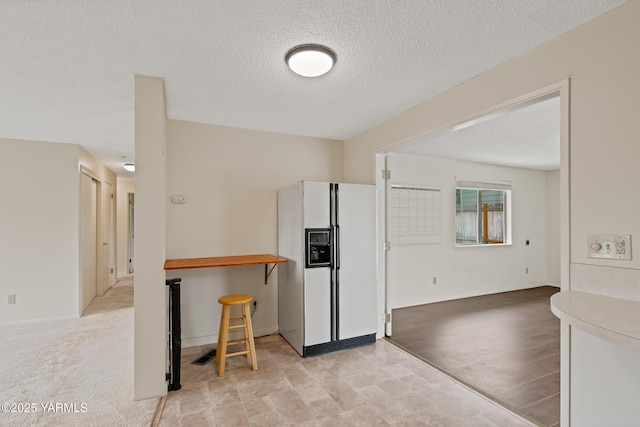 4905 Glenside Ct, Yakima, WA 98908 - kitchen featuring white fridge with ice dispenser and a textured ceiling