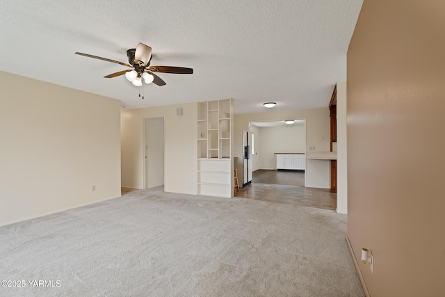 4905 Glenside Ct, Yakima, WA 98908 - unfurnished living room with ceiling fan, carpet, baseboards, and a textured ceiling