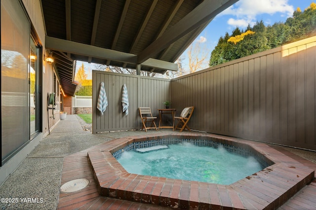 view of swimming pool with a fenced backyard and an outdoor hot tub