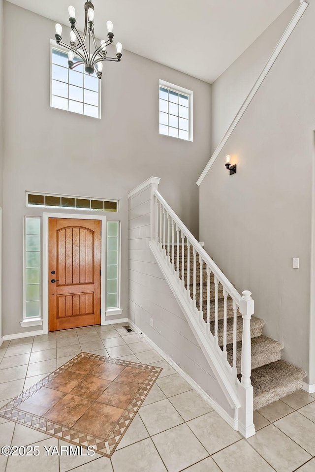 815 Trout Lake Ct, Yakima, WA 98901 - foyer with a high ceiling, stairs, tile patterned floors, and a chandelier