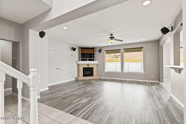 815 Trout Lake Ct, Yakima, WA 98901 - unfurnished living room with ceiling fan, light wood-type flooring, a tile fireplace, and recessed lighting