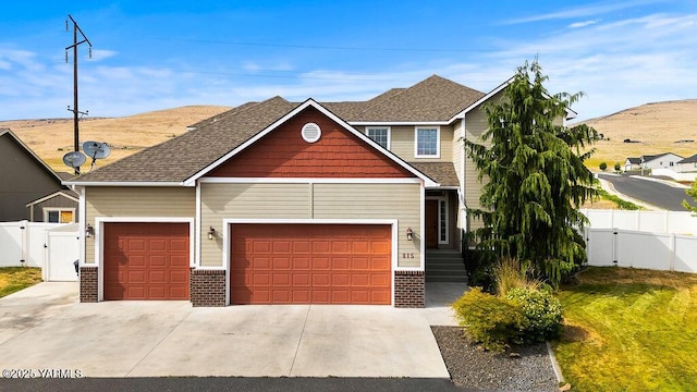 815 Trout Lake Ct, Yakima, WA 98901 - view of front of home featuring concrete driveway, brick siding, an attached garage, a gate, and a mountain view
