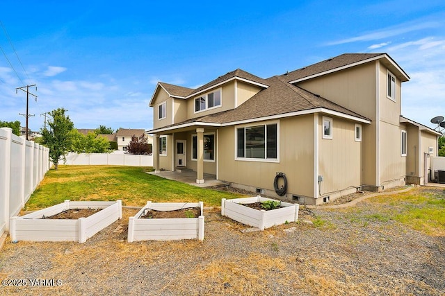 815 Trout Lake Ct, Yakima, WA 98901 - back of property with a vegetable garden, a shingled roof, a fenced backyard, and a patio area