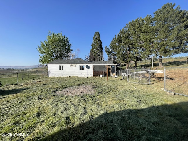 view of yard featuring fence and a rural view