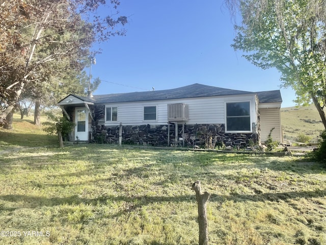 rear view of property with a lawn