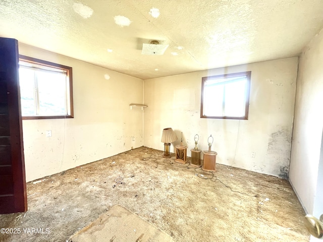 unfurnished room featuring a textured ceiling