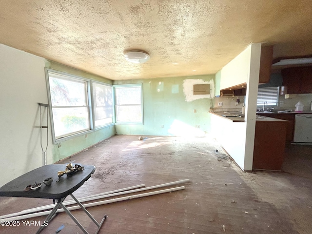 unfurnished living room with a sink and a textured ceiling